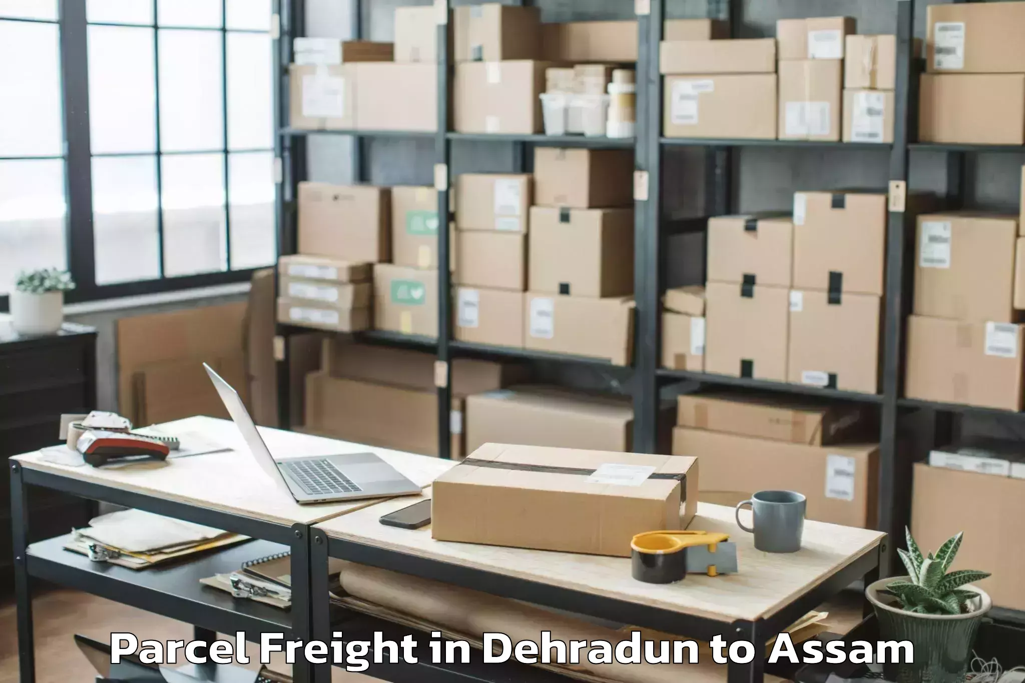 Book Dehradun to Morigaon Parcel Freight Online